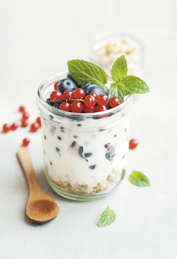 A delicious yogurt parfait with fresh berries and mint leaves, perfect for a healthy breakfast.